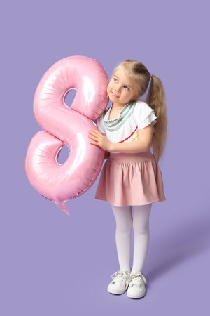 Cute little girl with pink air balloon in shape of figure 8 on lilac background. International...