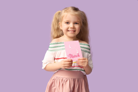 Cute little girl with greeting card on lilac background. International Women's Dayの写真素材