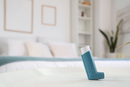 Asthma inhaler on table in bedroom, closeupの写真素材