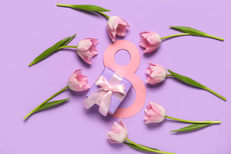 Figure 8 made of paper with beautiful tulips and gift box on lilac background. International Women's Dayの写真素材