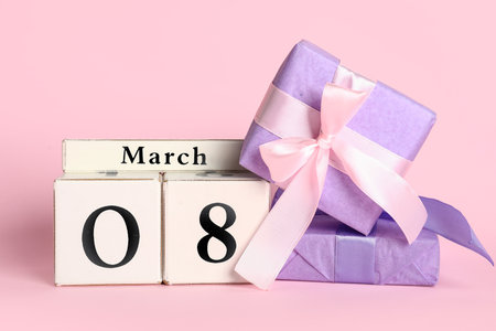 Cube calendar with date 8 MARCH and gift boxes on pink background. International Women's Dayの写真素材