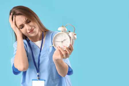 Stressed female doctor on blue background