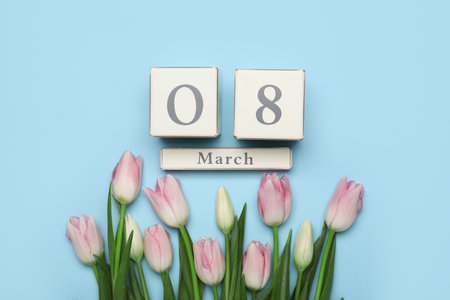 Calendar and tulips on light blue background. Women's Day celebrationの写真素材