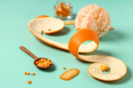Composition with fresh orange and peel on color background