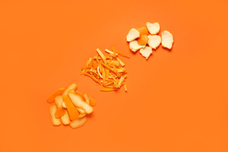 Heaps of fresh orange peel on color background