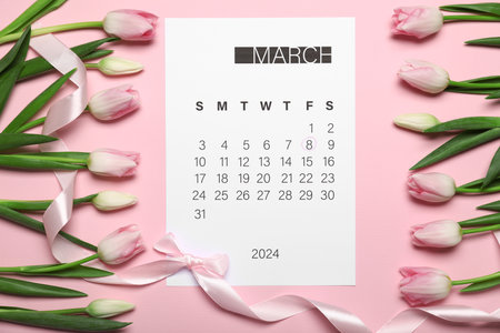 Calendar surrounded by tulips with pink ribbon on light pink background. Women's Day celebrationの写真素材