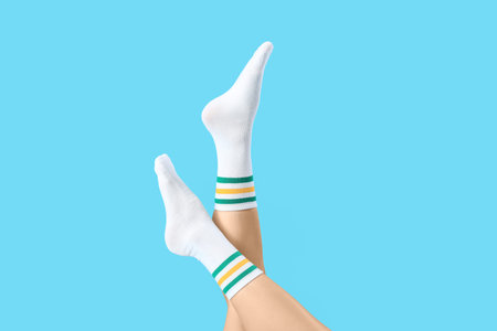Woman in white socks on blue backgroundの写真素材