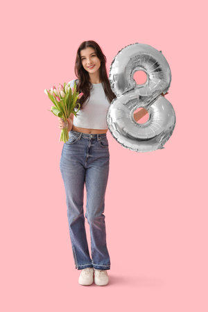 Pretty young woman with silver air balloon in shape of figure 8 and bouquet of beautiful tulips on...