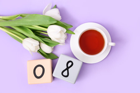 Cube calendar with date 08, beautiful white tulips and cup of tea on lilac background. International...