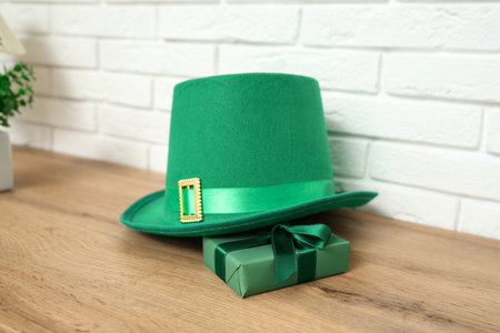Leprechaun's hat and gift box on table in living room, closeup. St. Patrick's Day celebrationの写真素材