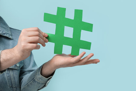 Man with hashtag sign on blue backgroundの写真素材