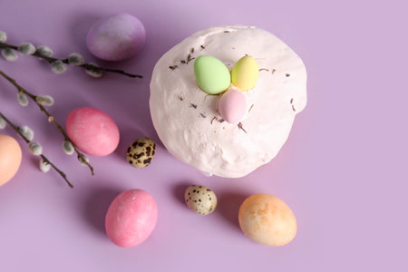 Composition with delicious Easter cake, pussy willow branch and painted eggs on color background....
