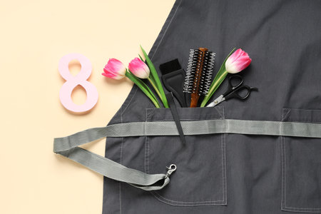 Composition with hairdresser's supplies, apron and tulip flowers on color background, closeup. International Women's Dayの写真素材