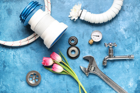 Composition with plumber's items and tulip flowers on color background. International Women's Dayの写真素材