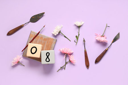 Composition with painter's tools and flowers on color background. International Women's Day