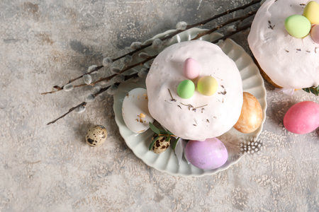 Composition with delicious Easter cakes and painted eggs in plate on color background. Top, viewの写真素材