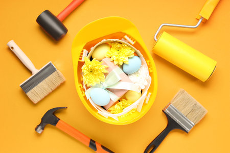 Composition with constructor's tools, Easter eggs and flowers on color backgroundの写真素材
