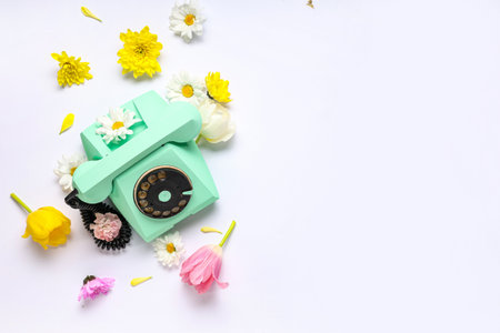 Retro telephone and beautiful flowers on white background. International Women's Dayの写真素材