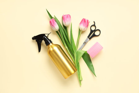 Composition with hairdresser's supplies and tulip flowers on color background. International Women's Day