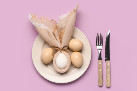 Beautiful table setting with Easter eggs, napkin and cutlery on purple background