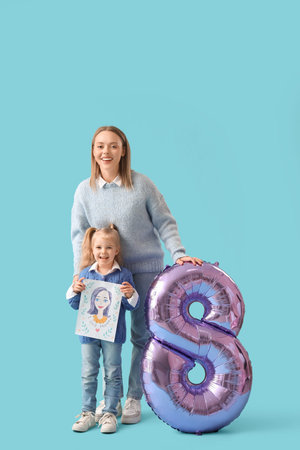 Little girl greeting her mother with drawing and balloon in shape of figure 8 on blue background....