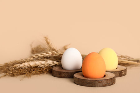 Painted Easter eggs and spikelets on beige background, closeupの写真素材