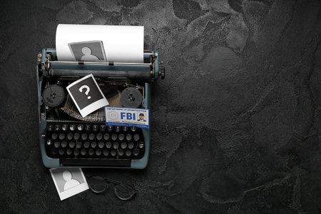Retro typewriter, document of FBI agent and question mark on dark background