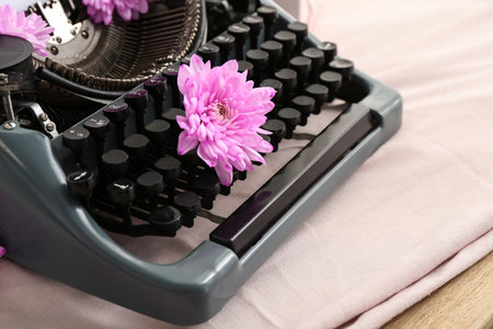 Vintage typewriter with flowers on cloth, closeupの写真素材