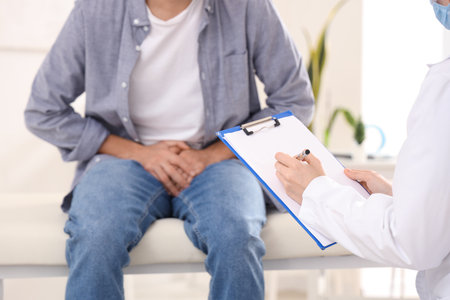 Urologist writing in clipboard at hospital, closeup. Prostate cancer awareness conceptの写真素材