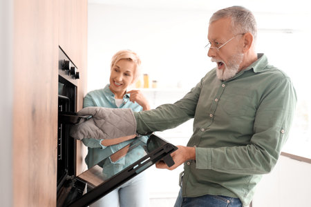 Mature couple cooking in kitchenの写真素材
