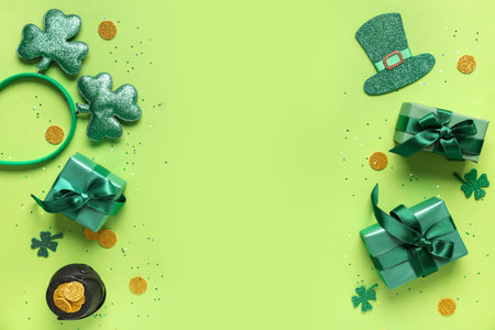 Gift boxes with headband, pot of golden coins and decor for St. Patrick's Day celebration on green backgroundの写真素材