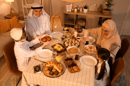 Happy Muslim family having dinner at home in evening. Ramadan celebrationの写真素材