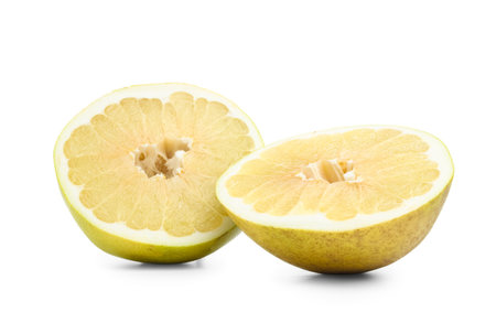 Halves of fresh pomelo fruit on white background