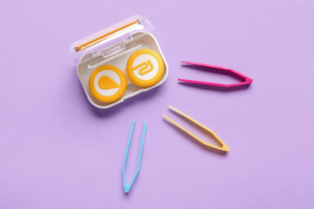 Container for contact lenses and tweeters on lilac background