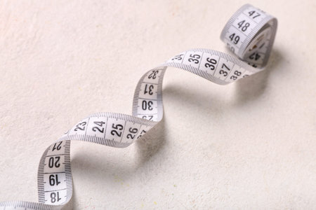 White measuring tape on light background