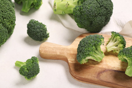 Fresh green broccoli with wooden board on white grunge backgroundの写真素材