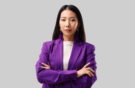 Asian young woman with beautiful earrings on white backgroundの写真素材