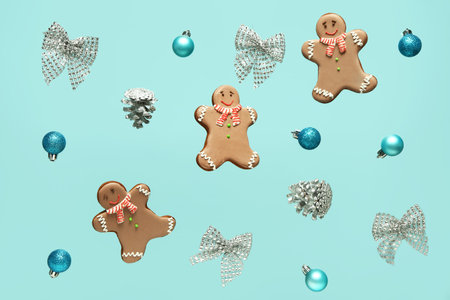 Tasty gingerbread cookies with Christmas decor on color background