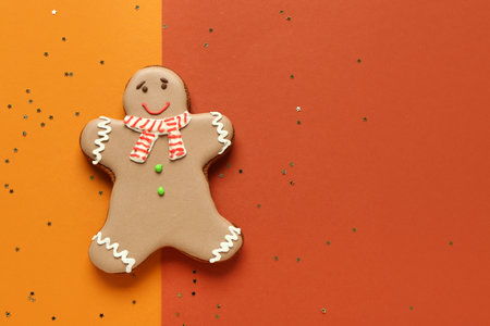 Christmas sweet gingerbread cookies and confetti on colorful backgroundの写真素材