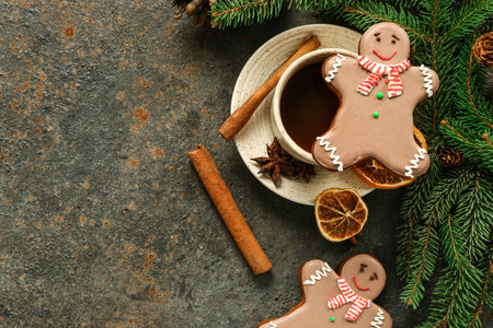 Christmas sweet gingerbread cookies with cinnamon and cup of hot chocolate on dark background