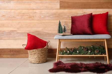 Pillows on soft bench with Christmas decor in roomの写真素材