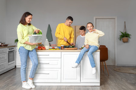 Happy family cooking in kitchenの写真素材