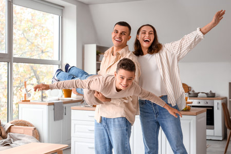 Little boy with his parents having fun at homeの写真素材