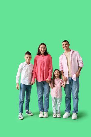 Little children with their parents holding hands on green backgroundの写真素材