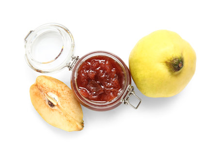Jar of sweet jam and quince fruits on white backgroundの写真素材