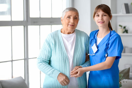 Senior woman with caregiver at homeの写真素材