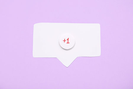 Speech bubble with +1 icon on lilac background. New messageの写真素材