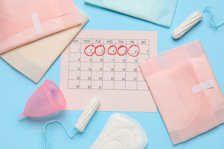 Composition with menstrual calendar and feminine hygiene products on color backgroundの写真素材