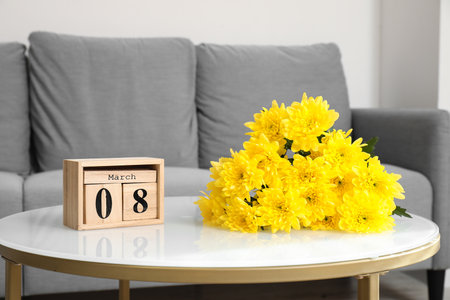 Yellow flowers with calendar on coffee table in living room. International Women's Day celebrationの写真素材