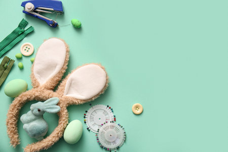 Bunny ears with Easter eggs and tailor supplies on turquoise backgroundの写真素材